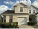 Charming two-story home featuring an attached garage and well-maintained front yard with mature landscaping at 6252 Olivedale Dr, Riverview, FL 33578