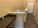 Hallway featuring tan walls, a landing desk, and natural light at 6252 Olivedale Dr, Riverview, FL 33578
