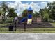 Community playground with slide, climbing wall, and protective mulch surfacing at 6252 Olivedale Dr, Riverview, FL 33578