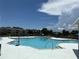 Large community pool with lounge chairs, tables, and umbrellas on a sunny day at 6252 Olivedale Dr, Riverview, FL 33578