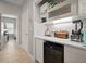 Home bar with a wine refrigerator, ample storage, and counter space for entertaining guests at 6408 Seasound Dr, Apollo Beach, FL 33572