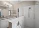 Spa-like bathroom with double vanity, granite counters, and a glass-enclosed shower for modern elegance at 6408 Seasound Dr, Apollo Beach, FL 33572