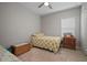 Comfortable bedroom features wood-look tile flooring, complemented by a cozy rug and matching wood furniture at 6408 Seasound Dr, Apollo Beach, FL 33572