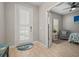 Cozy bedroom featuring neutral paint, a comfortable chair, and an adjacent door at 6408 Seasound Dr, Apollo Beach, FL 33572