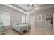 Neutral bedroom with tray ceiling, offering a peaceful retreat with natural lighting at 6408 Seasound Dr, Apollo Beach, FL 33572