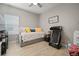 Well-lit bedroom featuring a comfortable daybed, neutral walls, and stylish wood-look tile flooring at 6408 Seasound Dr, Apollo Beach, FL 33572