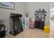Bedroom showcasing a treadmill and storage shelves, complemented by light-colored wood-look tile flooring at 6408 Seasound Dr, Apollo Beach, FL 33572