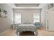Cozy bedroom bathed in natural light, complete with a tray ceiling for added character at 6408 Seasound Dr, Apollo Beach, FL 33572