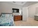 Comfortable bedroom featuring neutral paint, a large window, TV and furnishings at 6408 Seasound Dr, Apollo Beach, FL 33572