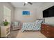 Comfortable bedroom featuring neutral paint, a large window, TV and furnishings at 6408 Seasound Dr, Apollo Beach, FL 33572