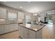 Bright kitchen features white cabinets, stainless appliances, granite countertops, and island with views of the backyard at 6408 Seasound Dr, Apollo Beach, FL 33572
