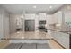 Bright kitchen featuring stainless appliances, granite countertops, a kitchen island, and ample cabinet space at 6408 Seasound Dr, Apollo Beach, FL 33572