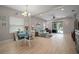 Open-concept living room and dining area with natural light, neutral tones, and access to the backyard at 6408 Seasound Dr, Apollo Beach, FL 33572