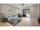 Bright living room featuring a ceiling fan, a comfortable couch, and a view of the screened in patio at 6408 Seasound Dr, Apollo Beach, FL 33572