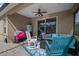 Relaxing covered patio with comfortable seating, ceiling fan, and view of backyard at 6408 Seasound Dr, Apollo Beach, FL 33572