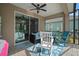 Inviting outdoor patio with comfortable seating, floral rug, ceiling fan, and access to backyard at 6408 Seasound Dr, Apollo Beach, FL 33572