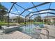 Relaxing screened-in pool area with a spa and comfortable seating, perfect for outdoor enjoyment at 6408 Seasound Dr, Apollo Beach, FL 33572