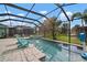 Enclosed pool area with a spa, in ground pool, a basketball hoop, and two beach chairs at 6408 Seasound Dr, Apollo Beach, FL 33572