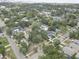 An aerial view captures a dense neighborhood with mature trees, diverse homes, and visible city skyline at 659 26Th S Ave, St Petersburg, FL 33705