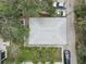 An aerial view of a house showing the roof, backyard with green space and palm trees, and surrounding vehicles at 659 26Th S Ave, St Petersburg, FL 33705