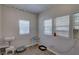 Neutrally painted bedroom with two windows, durable laminate flooring and basic shelving at 659 26Th S Ave, St Petersburg, FL 33705