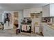 Efficient kitchen with white cabinetry, stainless steel appliances, and an open doorway to the bedroom at 659 26Th S Ave, St Petersburg, FL 33705