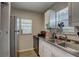 Functional kitchen featuring white cabinetry, modern appliances, and a view of the dining area at 659 26Th S Ave, St Petersburg, FL 33705