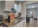 Functional kitchen featuring white cabinetry, modern appliances, and a view of the dining area at 659 26Th S Ave, St Petersburg, FL 33705