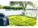 Spacious backyard with lush green grass and white vinyl fence at 6804 Pleasant Oaks Pl, Riverview, FL 33578