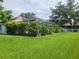 Spacious backyard featuring a screened-in lanai surrounded by lush landscaping, providing a private outdoor space at 6804 Pleasant Oaks Pl, Riverview, FL 33578