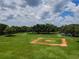 Overhead view of baseball field within the community, surrounded by expansive green space and trees at 6804 Pleasant Oaks Pl, Riverview, FL 33578