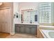 Bathroom with a double sink vanity and a glass block window at 6804 Pleasant Oaks Pl, Riverview, FL 33578