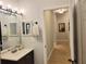 Bathroom features a vanity with a framed mirror and access to the hallway at 6804 Pleasant Oaks Pl, Riverview, FL 33578