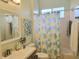Bright bathroom with a shower/tub combo and a pineapple print shower curtain at 6804 Pleasant Oaks Pl, Riverview, FL 33578
