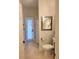 Well-lit bathroom featuring a shower, toilet, and access to the backyard at 6804 Pleasant Oaks Pl, Riverview, FL 33578