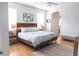 Bright bedroom with wood frame bed, stylish nightstands, and a cozy rug at 6804 Pleasant Oaks Pl, Riverview, FL 33578