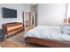 Bedroom featuring wood dresser and a mounted TV for convenient entertainment at 6804 Pleasant Oaks Pl, Riverview, FL 33578