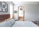 Bright bedroom with light blue linens and bath view through an archway at 6804 Pleasant Oaks Pl, Riverview, FL 33578