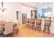 Dining area with a wooden table, seating for six, and seamless access to the kitchen bar at 6804 Pleasant Oaks Pl, Riverview, FL 33578