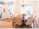 Dining room area with chandelier, neutral colors, wood floors, and lots of natural light at 6804 Pleasant Oaks Pl, Riverview, FL 33578