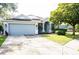 Charming single-story home featuring a two-car garage, well-manicured lawn, and inviting covered entry at 6804 Pleasant Oaks Pl, Riverview, FL 33578