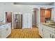 Bright kitchen with granite countertops, stainless steel refrigerator, and white cabinetry at 6804 Pleasant Oaks Pl, Riverview, FL 33578