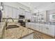 Modern kitchen with granite countertops, stainless steel appliances, and ample cabinet space at 6804 Pleasant Oaks Pl, Riverview, FL 33578