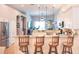 Open-concept kitchen with breakfast bar, pendant lighting, and views into the living area at 6804 Pleasant Oaks Pl, Riverview, FL 33578