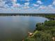 Breathtaking aerial view of the community lake with a wooden pier, offering stunning waterfront scenery at 6804 Pleasant Oaks Pl, Riverview, FL 33578