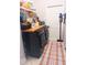 Functional laundry room with front load washer/dryer and overhead storage at 6804 Pleasant Oaks Pl, Riverview, FL 33578