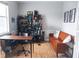 Bright home office with built-in shelves, desk, Peloton bike, seating and wood flooring at 6804 Pleasant Oaks Pl, Riverview, FL 33578
