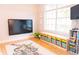 playroom with TV, storage, wood floors, play area and view to backyard at 6804 Pleasant Oaks Pl, Riverview, FL 33578