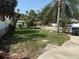 A spacious backyard with mature trees, chain link fence, and fire pit area at 740 7Th Sw Ave, Largo, FL 33770