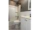 Bathroom showcasing white vanity, toilet, and bathtub with gray paint and black fixtures at 740 7Th Sw Ave, Largo, FL 33770